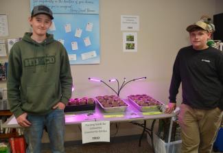 Students Payton Ball and JT Neugin planted seeds as a community service project in an effort to help the Cullowhee Community Garden.