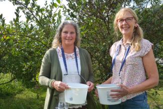 Marne Harris (left), Director of Southwestern Community College’s Small Business Center, picked blueberries with former Appalachian Farm School student, Cindy Anthony, who currently owns the Thomas Berry Farm in Cullowhee.