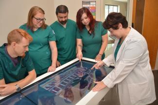 Female instructor providing demonstration to Respiratory Therapy students