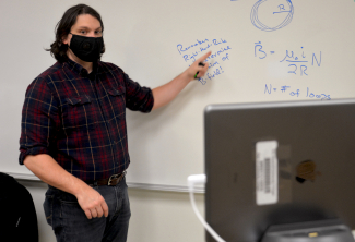 Man points at eraser board and looks into Hyflex camera