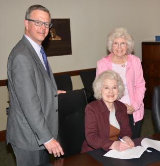 Doreyl Ammons Cain signs paperwork establishing a scholarship at SCC.