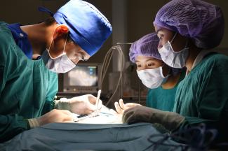 Surgeon and Surgical Tech work together in operating room.