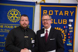 Picture of Sylva Rotary president Eddie Wells (left) shaking hands with SCC Foundation director Brett Woods.