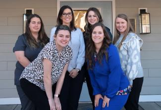 SCC Human Services Technology graduate Ashley Cook (back row, left) and second-year SCC Nursing student Elizabeth Cartwright (front left) are both employed by AWAKE Children’s Advocacy Center in Sylva. Also pictured are AWAKE employees, from left behind Cartwright: Crystal Jones, Executive Director; Maggie Grey, Forensic Interviewer/Case Manager; Paige Gilliland, Senior Forensic Interviewer; and Kristen Brady, Administrative Assistant.