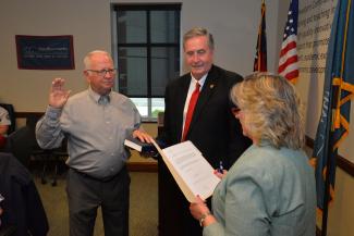 Gerald McKinney is sworn in as Dr. Don Tomas holds a bible.