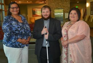 A man stands between two women inside a building on SCC's Jackson Campus.