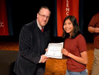 Student receives certificate from principal
