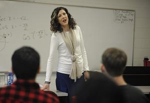 A female math instructor speaks to students